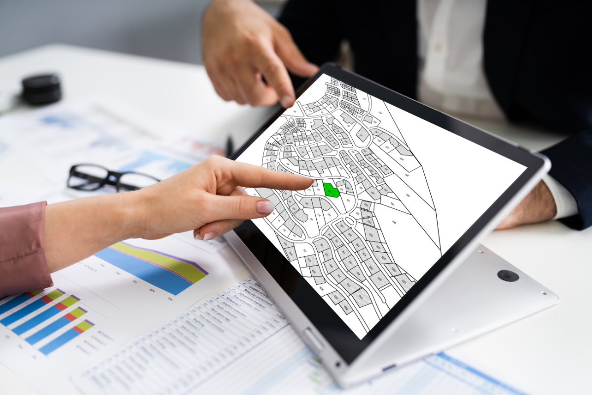 Person pointing at a map, representing land location services